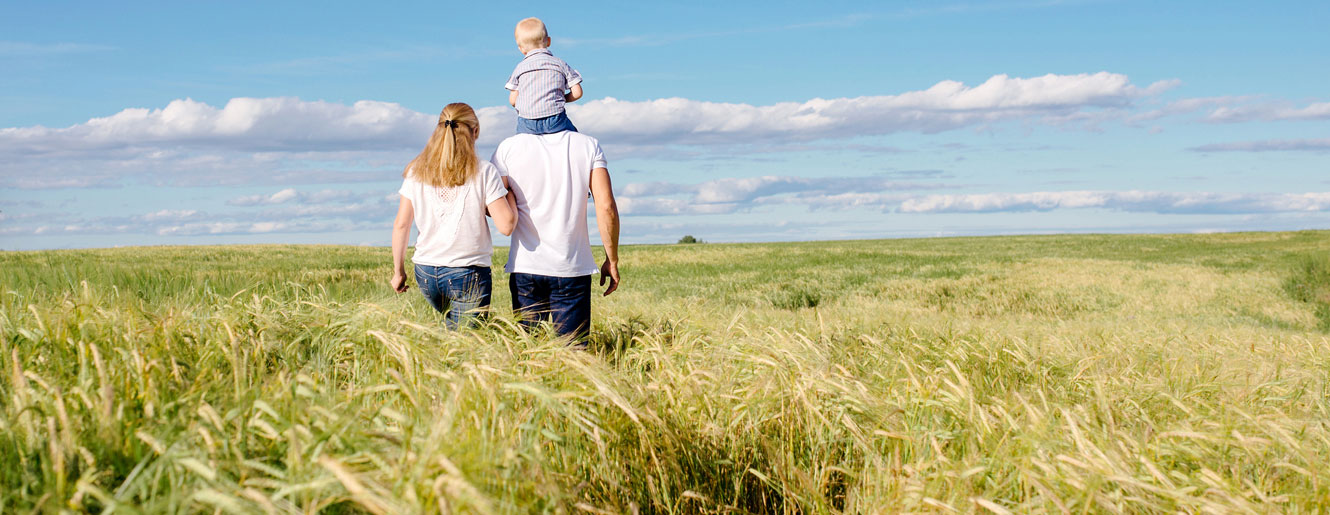 Family walking in tall grass